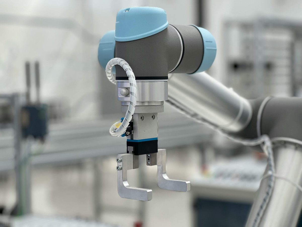 Robotic arms tending machines on a manufacturing line